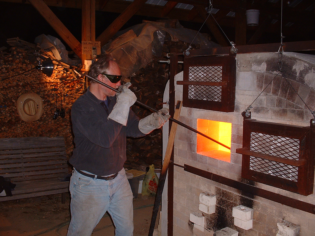 Tony Moore stoking the kiln